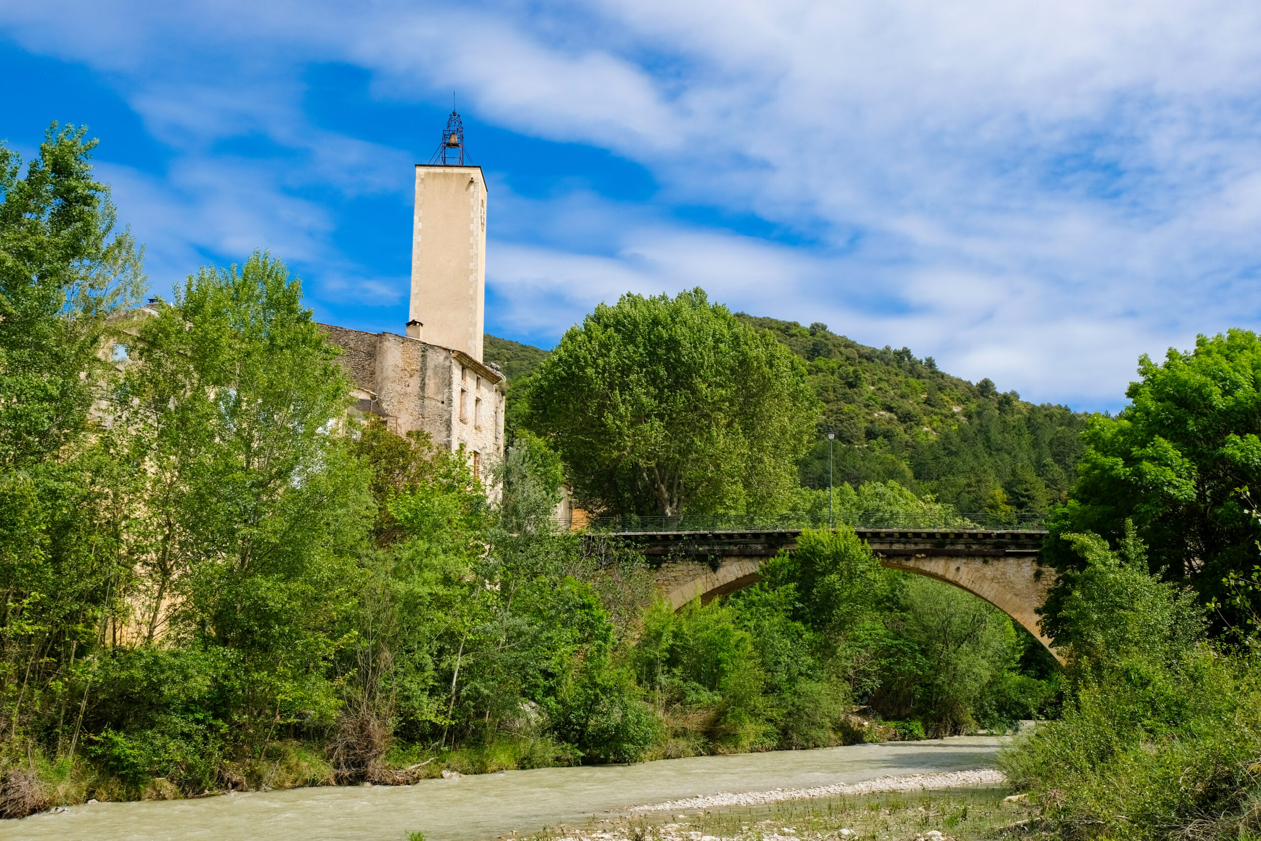 Vue du pont et du Beffroi de Mollans-sur-Ouvèze depuis la rivière.